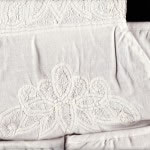 A closeup version of the Battenburg Lace beautifully crafted to adorn a multi-task organizer that can be tied to the crib. There is even a pocket to insert a roll of paper towel.