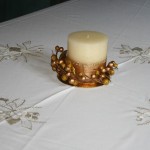 Golden Moments tablecloth beautifully embroidered white candles with gold thread accents on easy care Viscose & Polyester blend.