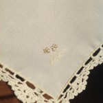 Touch of Gold Napkin features beautifully embroidered Candles with gold thread embroidered Ribbons & Hearts on Ecru easy care Viscose & Polyester blend. Full hand crocheted lace edge.