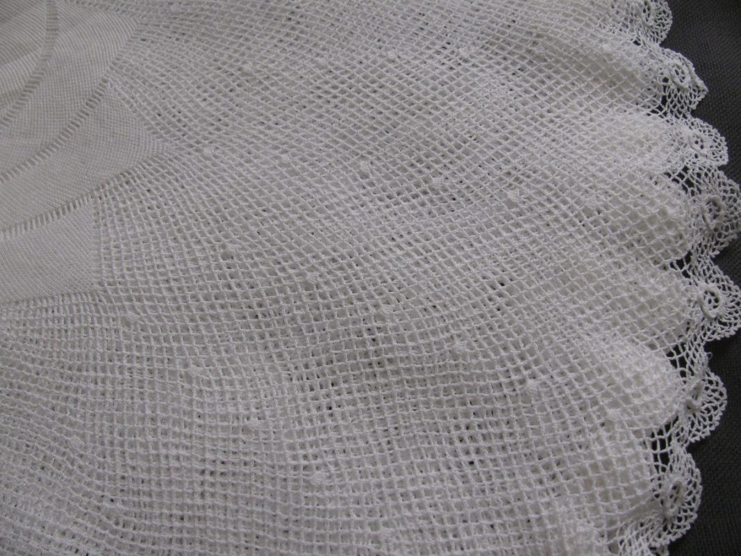 Close-up of the Fine Pinwheel Crochet Lace & Irish Rose Trim Round Tea Tablecloth, featuring delicate white lace with a mesh pattern, scalloped edges, and intricate stitching for a soft, detailed texture.