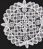 A circular, white lace doily with an intricate pattern of loops, floral shapes, and geometric designs rests against a black background in this elegant piece from the Home Decor DIY Framed Doilies Art: Designer Choice Wall Decor collection. The delicate lacework adds a touch of refined detail to any space.