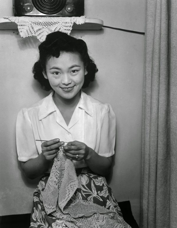 "Our Crochet Lace Doily design featured in Ansel Adams' 1943 photo at Manzanar Relocation Camp, showcasing Mrs. Dennis Shimizu with her creation."