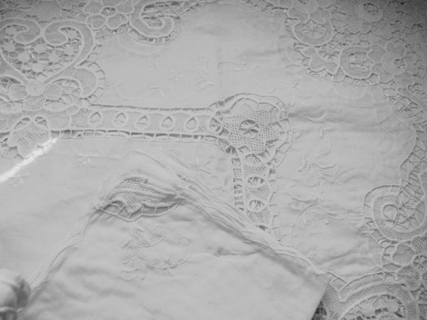 "Exquisite Point de Venise needle lace & hand-embroidered satin floral accents on cotton organdy tablecloth. Elegance in every stitch."