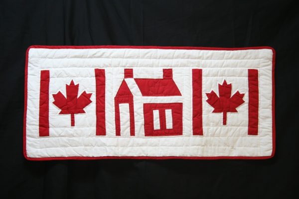 "Discover the charm of our Red and White hand-quilted Maple Leaf and 'Our Home' School House design. Perfect as a table runner or window valance!"