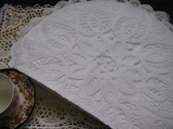 "Sturdy Battenburg Lace crafted with woven tapes and intricate stitching. Our tea cozy, adorned with lace brides and bars, fits larger Victorian teapots."