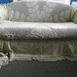 A Peacock Lace Sofa covered with its coordinating white slip cover.