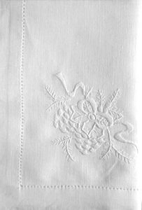 White linen Guest Towel with a subtle floral embroidery design and a decorative stitched border along the edges. The fabric appears smooth and elegant.
