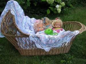 Pink Blue & White Crochet Lace tablecloth makes a cheery and fun way to decorate. How about a bassinet full of fun stuff, that is, stuffed animals