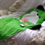 Apple Green CAT quillow with line drawing embroidery and zipper closure.