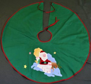Vintage Appliqué chimney skirt is ideal to decorate any table setting. Red piping edge on colour fast Green Cotton fabric Featuring Santa Claus the jolly old man coming down a chimney...ready to deliver Christmas presents to all children!