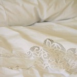 White Battenburg Lace with embroidered accents top sheet and matching pillow case.