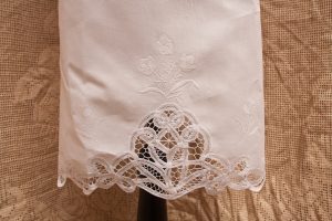 Close up view of White embroidered Tulips on the apron. Battenburg Lace shaped like tulips is more pronounced.