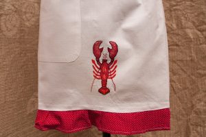 By the Sea: a whimsical apron for the kitchen! embroider red lobster. The Red and White Polka Dots edging adds a fun-loving humour.