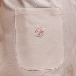 Pocket details of hand embroidered Dame Rocket full apron.