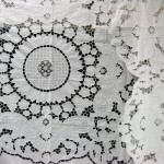 Lotus Blossoms: a very elaborate bed cover with cutwork embroidered lotus blossoms throughout the entire bed cover and sunflower motif in the centre.