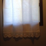 Crocheted lace trim cotton curtain panels.