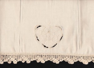 Ecru Queen of Hearts Embroidered Guest towel features a full hand crocheted lace edge in a ladder pattern