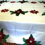 Classic and elegant Cranberry Poinsettia appliqué on easy care polyester is very economically priced.