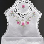 Crochet Lace trimmed with pink cross stitched rose buds bread basket cover or bun warmers 