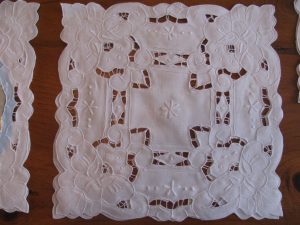 Cutwork Daffodils pure and white Linen square doily as place setting.