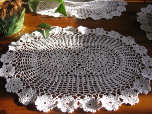 Hand crocheted Flower Wheel oval lace place mat with rosette edging