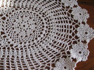 Hand crocheted Flower Wheel oval lace place mat with rosette edging