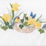 Daffodils and Blue Birds in a beautiful embroidered tablecloth of blues & yellows.