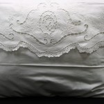 An exquisite Crisp White Cotton rich pillow case in envelope style. Beautiful Cutwork embroidered details with a very fine hand crocheted full lace edge. Standard size only.