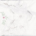 Flower Basket shower curtain is white cotton cutwork embroidery with a hint of colour.