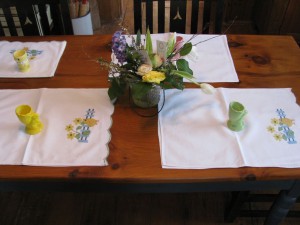 Picket Fence with Contour Embroidered Chicks and Sunflowers guest towels as place mats for Easter family dinner.
