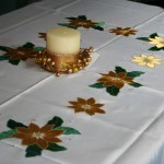 Classic and elegant Gold Poinsettia appliqué on easy care polyester is very economically priced.