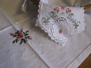 Hemstitched Rose in Rose colour on refreshing crisp white cotton with folded border.