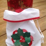 The Appliqué stitches of this Holly Wreath Gift Bag are so even & minute that only an expert embroiderer can master, an incredible 18-20 stitches per inch. With a wide bottomed gusset, It can even hold a bottle of Wine.