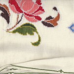 Close up of tent stitched peony with tent stitched hemmed border.