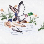 Paired Mallard Ducks in flight embroidered tablecloth.
