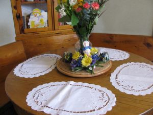 Linen Easter Lily oval place mat an elegant setting for cordial family gathering. 