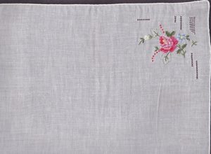 A single Rose expertly hand embroidered of very fine & even Petit Point stitches on prestine white Swiss handkerchief cotton of premium quality.