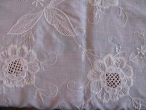 Chrysanthemums embroidered on linen and polyester blend.