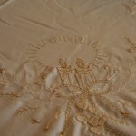 Touch of Gold tablecloths & Doilies features beautifully embroidered Candles with gold thread embroidered Ribbons & Hearts on Ecru easy care Viscose & Polyester blend. Full hand crocheted lace edge.