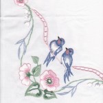 A beautiful adaptation of Barn Swallows, accented with Cosmos and cutwork embroidery.
