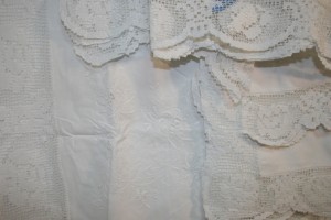 Hand knotted Modano Tuscan Lace embellished with Embroidered chrysanthemums Cushion Cover in Pristine White Cotton.